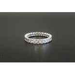 DIAMOND ETERNITY RING in platinum, the twenty-seven diamonds totalling approximately 1ct,