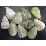 SELECTION OF GREEN MARBLE AND HARDSTONE PENDANTS of various sizes,