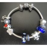 PANDORA MOMENTS SILVER CHARM BRACELET with a safety chain, seven charms, a clip and two spacers,