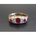 RUBY AND DIAMOND RING the central oval cut ruby flanked by two diamonds and a round cut ruby to