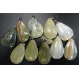 SELECTION OF GREEN MARBLE AND HARDSTONE PENDANTS of various sizes,