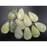 SELECTION OF GREEN MARBLE AND HARDSTONE PENDANTS of various sizes,