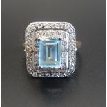 BLUE TOPAZ AND DIAMOND CLUSTER COCKTAIL RING the central emerald cut blue topaz approximately 1.