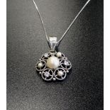 ATTRACTIVE DIAMOND AND PEARL SET PENDANT the central pearl in pierced surround set with alternating