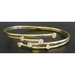 NINE CARAT GOLD BANGLE the multi strand front section set with CZ stones,