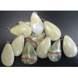 SELECTION OF GREEN MARBLE AND HARDSTONE PENDANTS of various sizes,