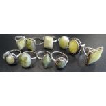 TEN SILVER RINGS all set with green marble and some with marcasite