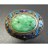 CHINESE JADE AND ENAMEL BROOCH the central oval carved jade section in enamelled floral decorated
