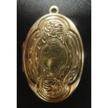 NINE CARAT GOLD LOCKET PENDANT the oval locket with floral and scroll decoration to the front