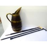 LARGE 19th CENTURY OAK AND BRASS BOUND JUG with a brass spout, handle and banding, 51cm high,