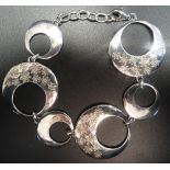 SILVER PIERCED DISC LINK BRACELET the larger links with floral decoration,