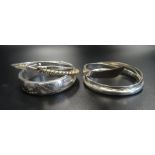 SIX SILVER BANGLES of various designs,