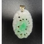 CARVED JADE PENDANT with stylised floral decoration, in unmarked gold mount, 3.