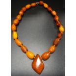 AMBER BEAD NECKLACE the irregular shaped and sized beads individually knotted and surrounding a