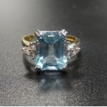 BLUE TOPAZ AND DIAMOND DRESS RING the large central emerald cut topaz approximately 2.