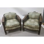 A PAIR OF CONTINENTAL STYLE MAHOGANY CARVED BERGERE ARMCHAIRS,