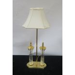 A CONTEMPORARY CUT GLASS AND BRASS MOUNTED TABLE LAMP,