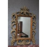 A CONTINENTAL GILT WOOD AND PAINTED MIRROR,