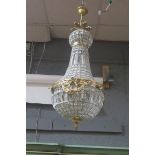 A CONTINENTAL GILT BRASS CUT GLASS BASKET SHAPED CENTRAL LIGHT,