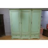 A CONTINENTAL BLUE AND WHITE PAINTED THREE DOOR WARDROBE, of break front outline,