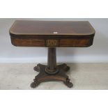 A REGENCY MAHOGANY AND GILT BRASS MOUNTED FOLDOVER TOP GAMES TABLE,