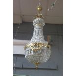 A CONTINENTAL GILT BRASS CUT GLASS BASKET SHAPED CENTRAL LIGHT,