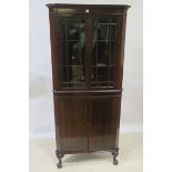 A MAHOGANY CORNER CABINET, with astragal glazed doors and gadrooned carving,
