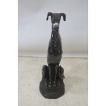 A BRASS FIGURE, modelled as a hound shown seated,