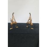 A PAIR OF COPPER AND BRASS AESTHETIC FIRE DOGS,