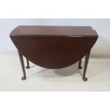 A FINE GEORGIAN MAHOGANY DROP LEAF TABLE the oval top raised on cabriole legs with pad feet