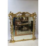 A CARVED GILTWOOD OVERMANTLE MIRROR,