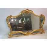 A GILT FRAMED OVERMANTLE MIRROR,