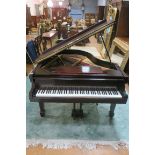 A DANEMANN BOUDOIR GRAND PIANO, raised on square tapering spade legs with castors,