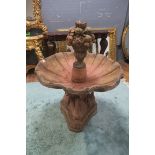 A TERRACOTTA FOUNTAIN, with a scalloped bowl surmounted with basket filled with fruiting vines,