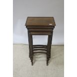 A GEORGIAN STYLE MAHOGANY NEST OF FOUR TABLES, the rectangular top with raised rim,