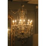 A CONTINENTAL GILT BRASS AND GLASS TWELVE LIGHT CHANDELIER