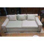 A CONTEMPORARY RECTANGULAR FRAMED THREE SEATER SOFA,