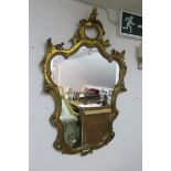 A CONTINENTAL GILT FRAMED MIRROR,