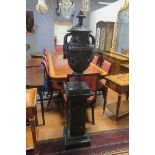 A CAST IRON URN,