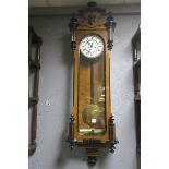 A WALNUT AND EBONISED WALLCLOCK, in neo-classical style,