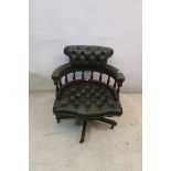 A VICTORIAN STYLE GREEN LEATHER UPHOLSTERED TUB SHAPED LIBRARY CHAIR,