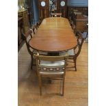 A FINE REGENCY STYLE MAHOGANY ELEVEN PIECE DINING SUITE, comprising ten chairs,