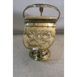 A BRASS HELMET SHAPED FUEL BIN,