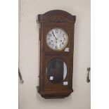 A 20th CENTURY OAK FRAMED WALL CLOCK,