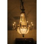 AN IMPRESSIVE GILT BRASS AND CUT CRYSTAL BASKET SHAPED CHANDELIER,