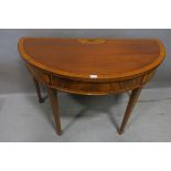 A SHERATON STYLE MAHOGANY AND SATINWOOD CROSSBANDED SIDE TABLE, of demi-lune outline,