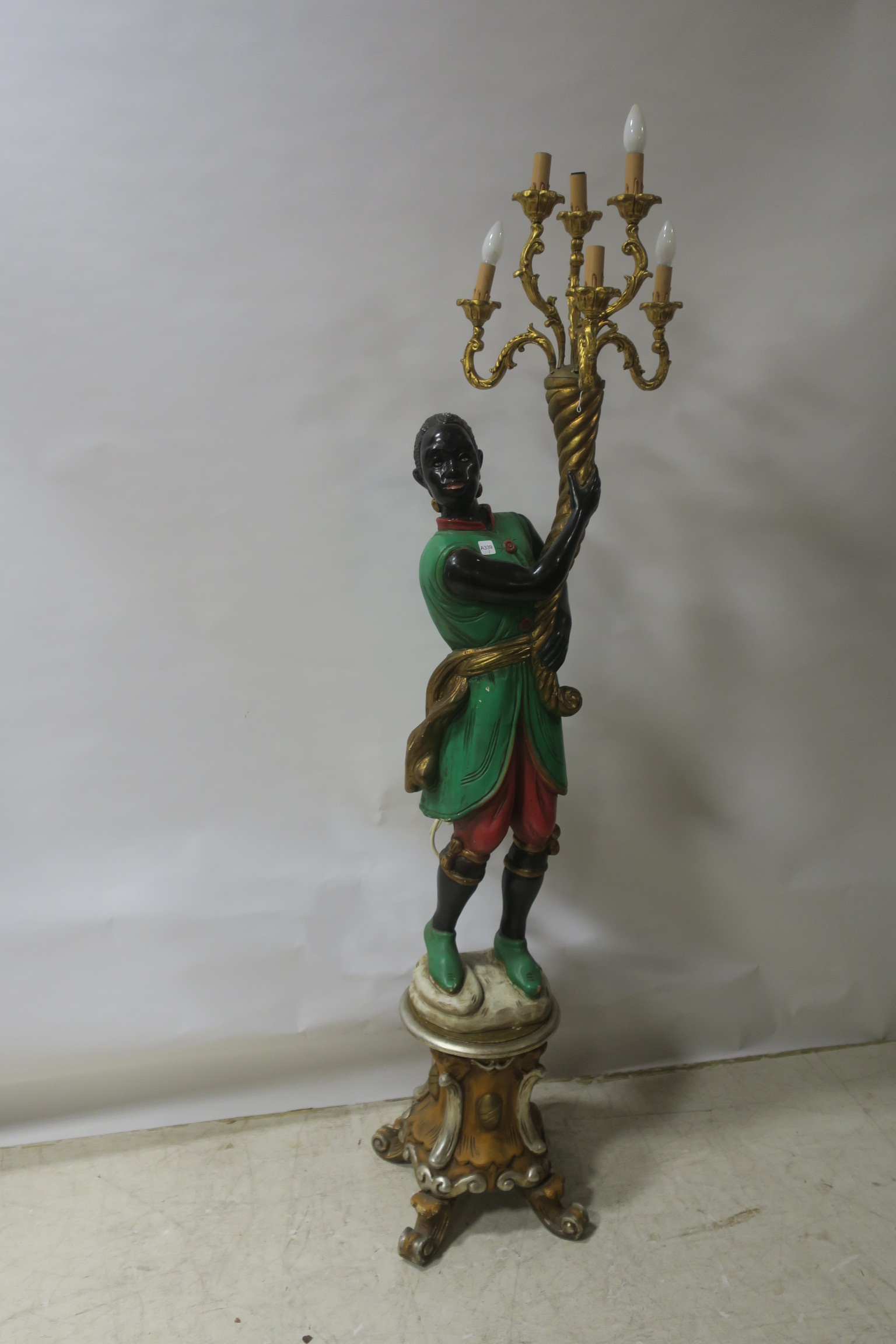 A CARVED WOOD MODEL OF A GREEN AND RED PAINTED BLACKAMOOR,