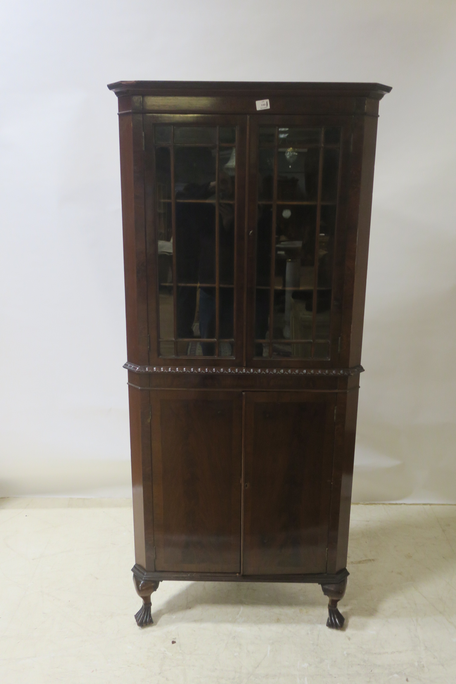 A MAHOGANY CORNER CABINET, with astragal glazed doors and gadrooned carving,