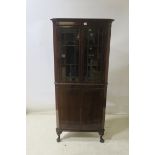 A MAHOGANY CORNER CABINET, with astragal glazed doors and gadrooned carving,