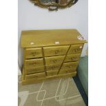 A CONTEMPORARY CARVED WOOD CHEST OF DRAWERS,